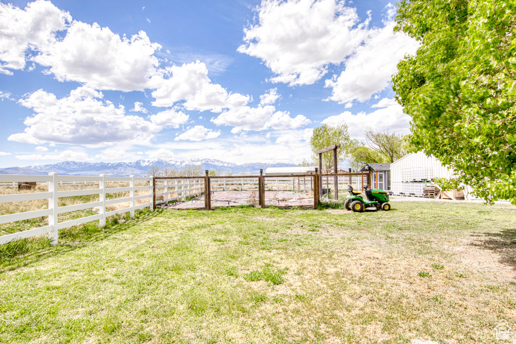 View of yard with a mountain view and fence
