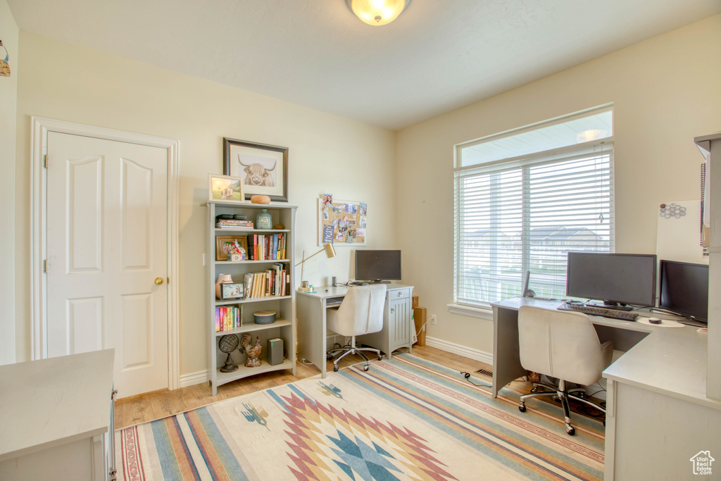 Home office featuring baseboards and light wood-style floors
