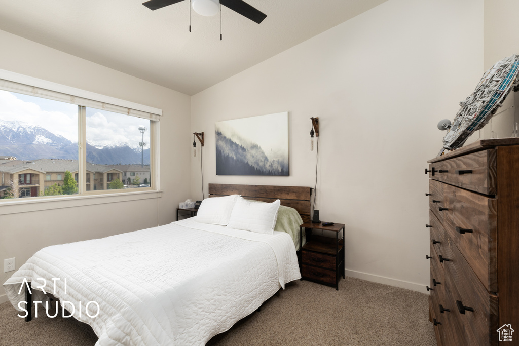 Bedroom with carpet flooring, a mountain view, a ceiling fan, baseboards, and lofted ceiling