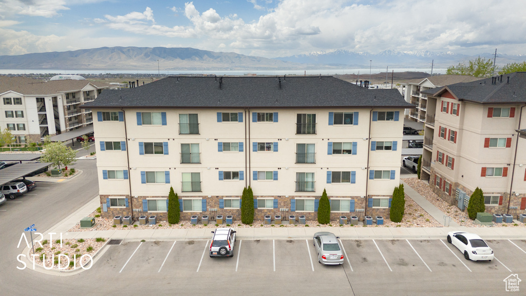 View of property featuring uncovered parking and a mountain view