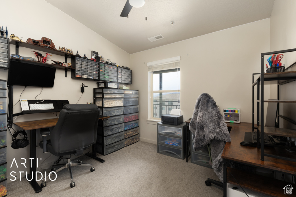 Office space with ceiling fan, carpet floors, and visible vents