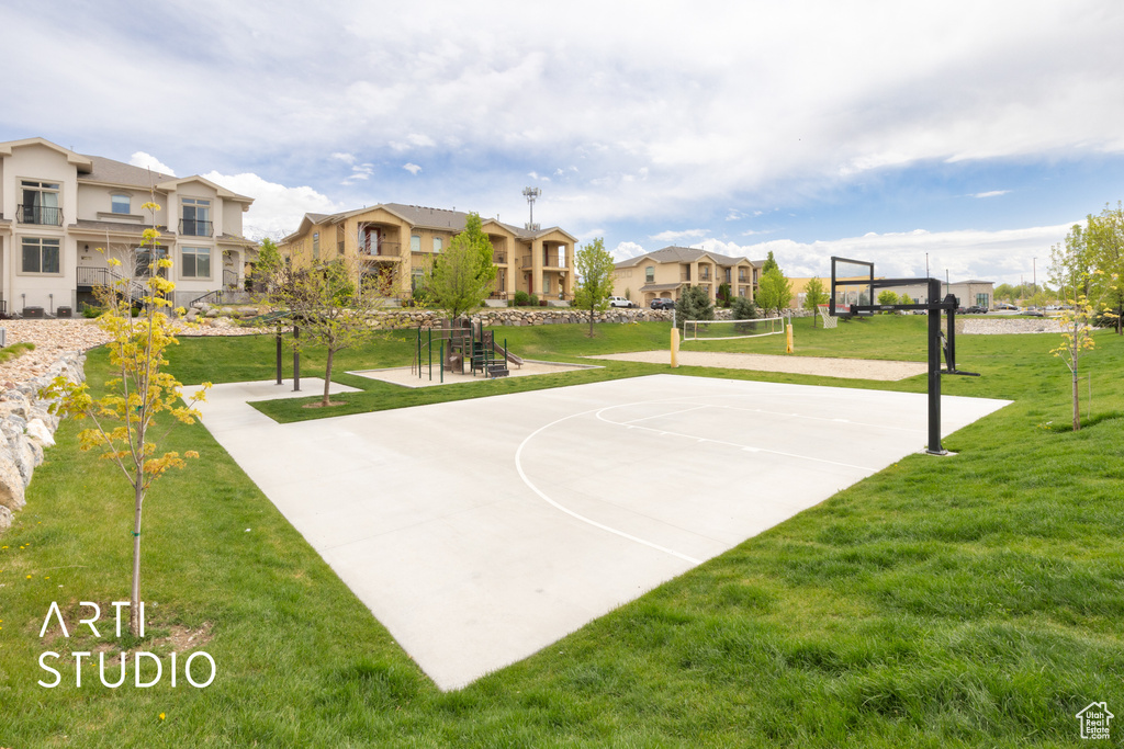 View of basketball court with volleyball court, a residential view, and a lawn