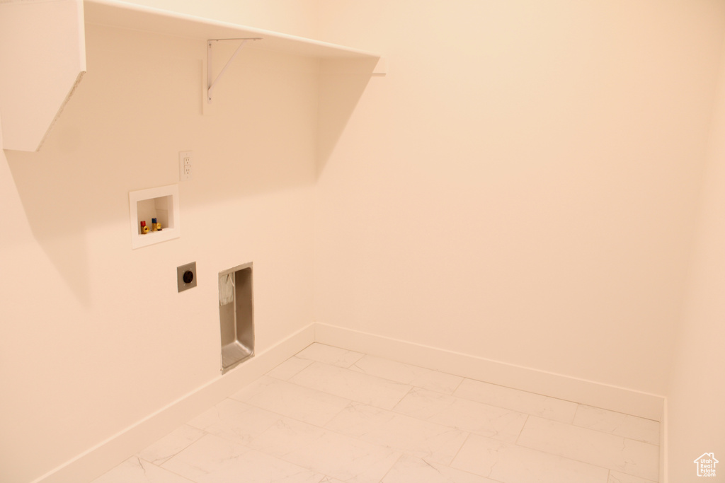 Laundry area featuring washer hookup, marble finish floor, laundry area, and baseboards