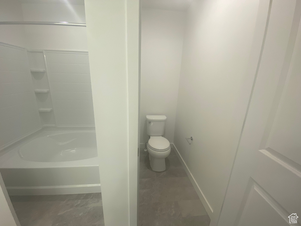 Bathroom featuring toilet and baseboards