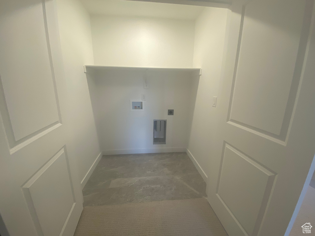 Laundry area featuring baseboards, hookup for a washing machine, electric dryer hookup, and laundry area