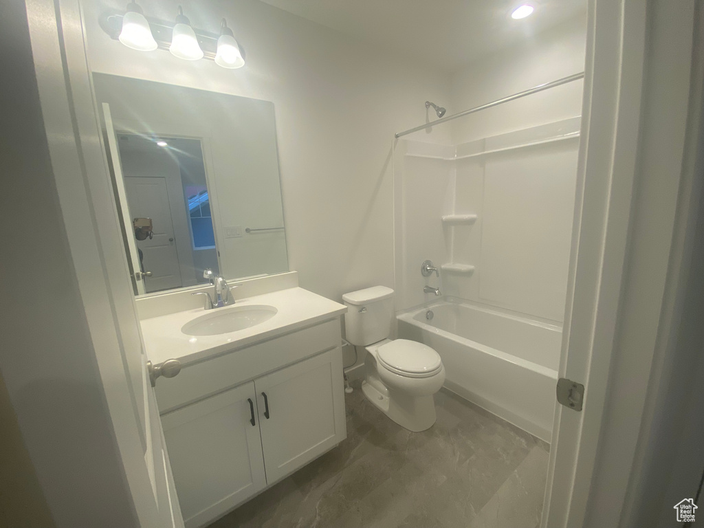 Full bath with toilet,  shower combination, and vanity