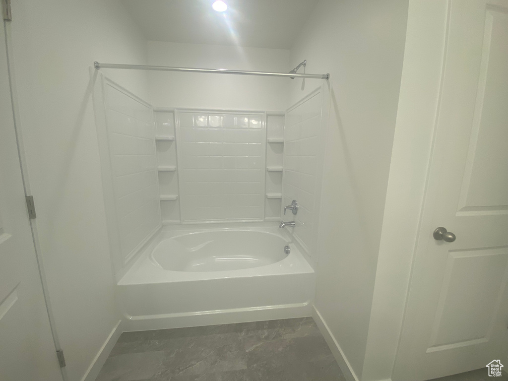 Bathroom with tub / shower combination and baseboards