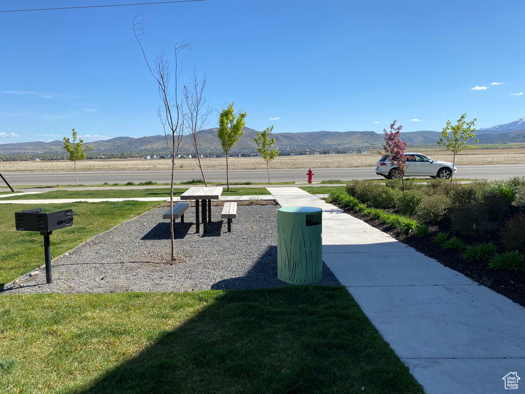 View of property\\\\\\\'s community featuring a yard and a mountain view