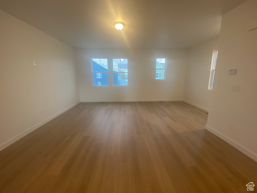 Spare room featuring baseboards and light wood-style floors