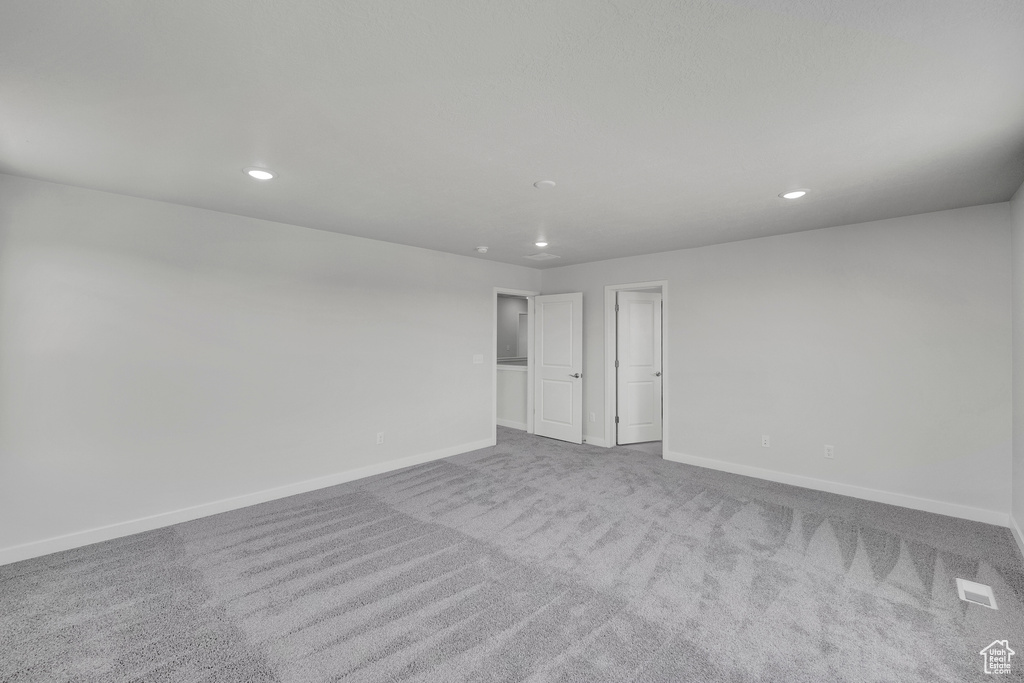 Spare room with baseboards, carpet floors, and recessed lighting