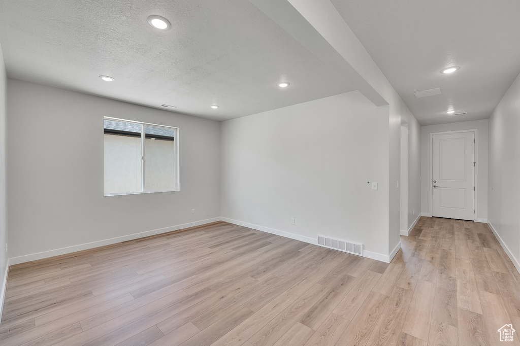 Spare room with light wood-type flooring, recessed lighting, and baseboards