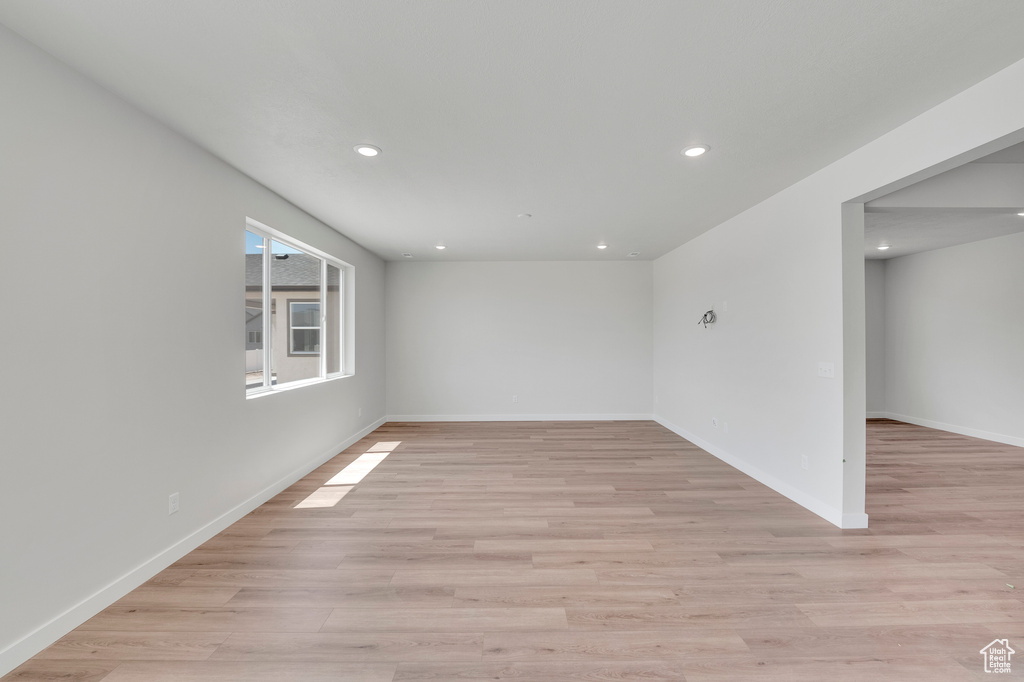 Spare room with recessed lighting, light wood-style flooring, and baseboards