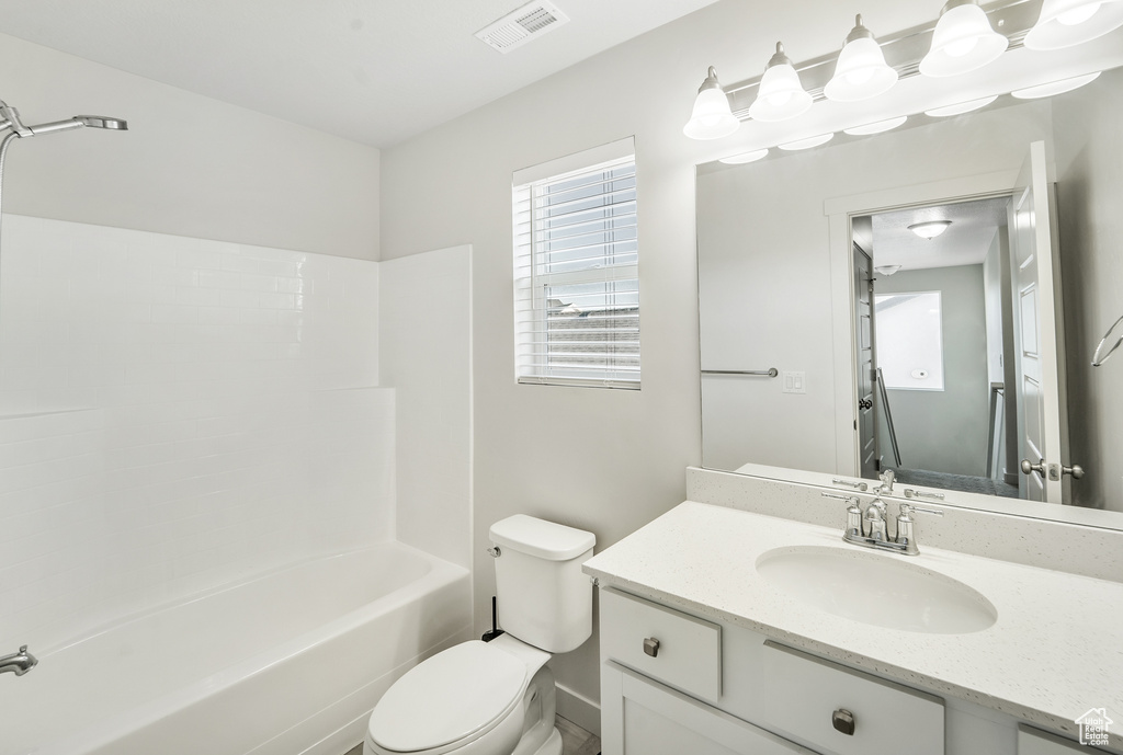 Full bath with toilet, visible vents, washtub / shower combination, and vanity