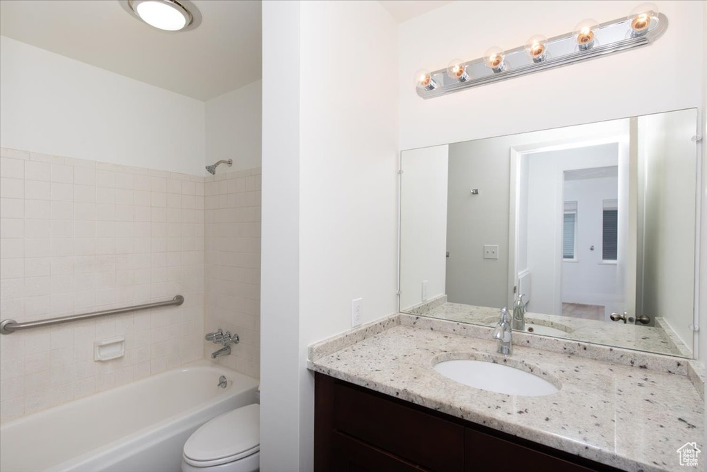 Full bathroom featuring tub / shower combination, toilet, and vanity