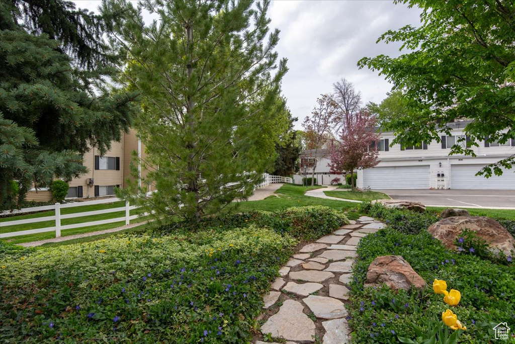 View of yard with fence and an attached garage
