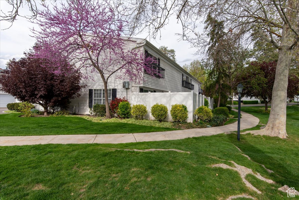 View of side of home with a lawn
