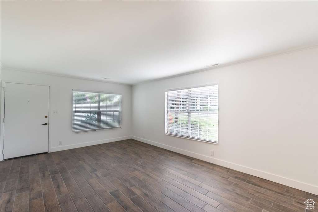 Interior space with dark wood-style floors and baseboards