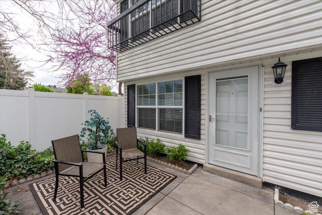Doorway to property with a patio area and fence