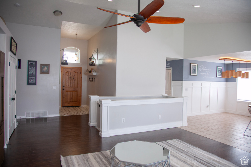Living room with recessed lighting, high vaulted ceiling, a ceiling fan, visible vents, and wood finished floors