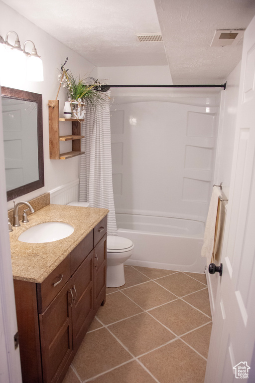 Bathroom with tile patterned flooring, toilet, vanity, visible vents, and shower / tub combo with curtain