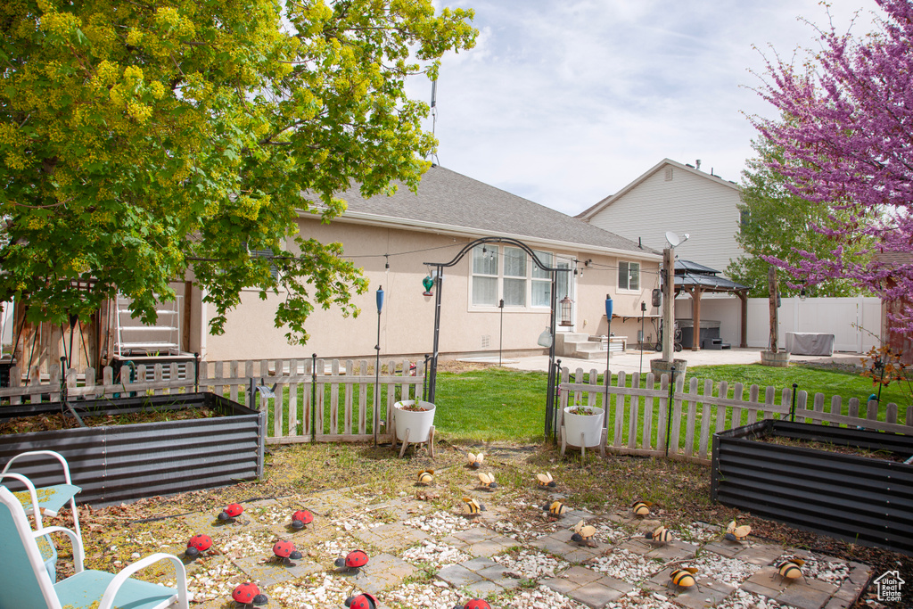 View of patio / terrace with a gazebo, a vegetable garden, and fence private yard
