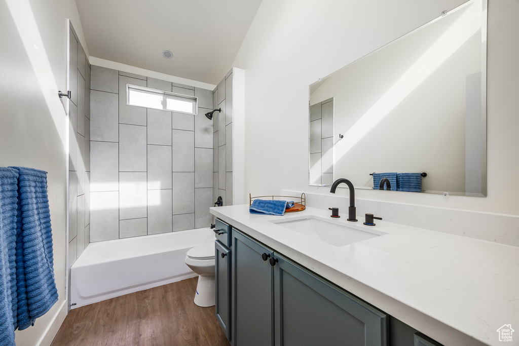 Full bathroom featuring bathtub / shower combination, wood finished floors, toilet, and vanity