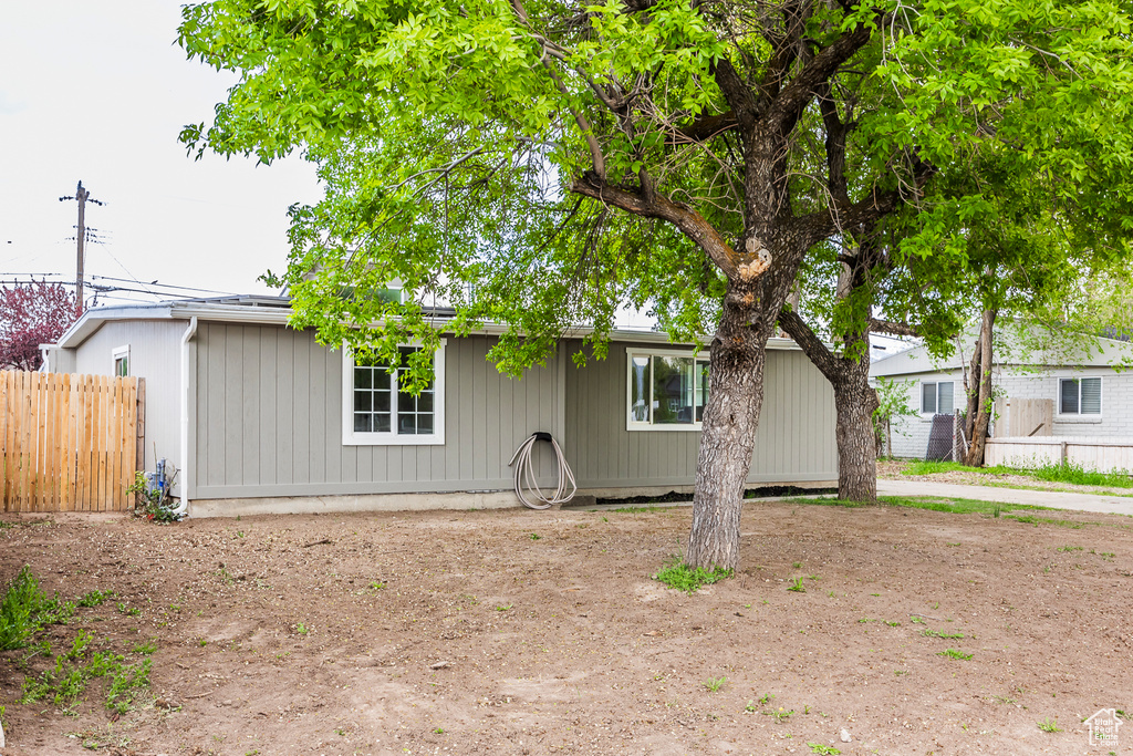 Ranch-style house featuring fence