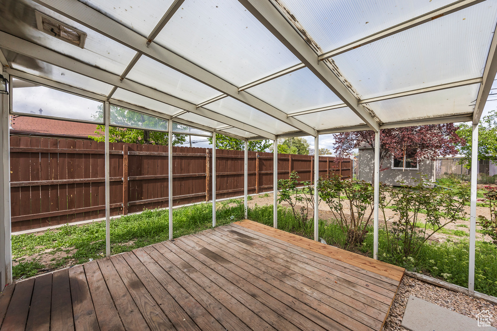 Wooden deck featuring a fenced backyard