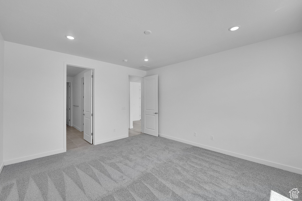 Unfurnished bedroom featuring carpet flooring, recessed lighting, and baseboards