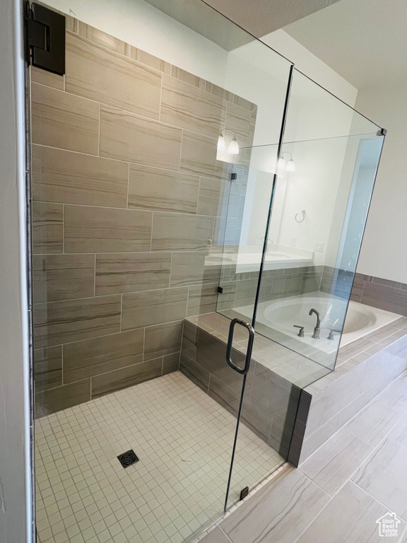 Full bathroom featuring a bath and a stall shower