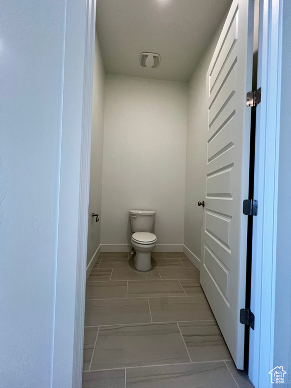 Bathroom with baseboards and toilet
