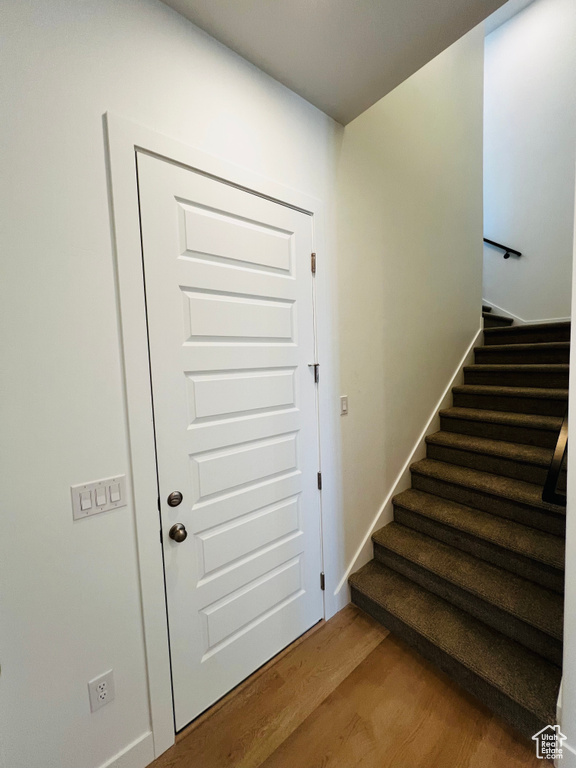 Staircase featuring wood finished floors