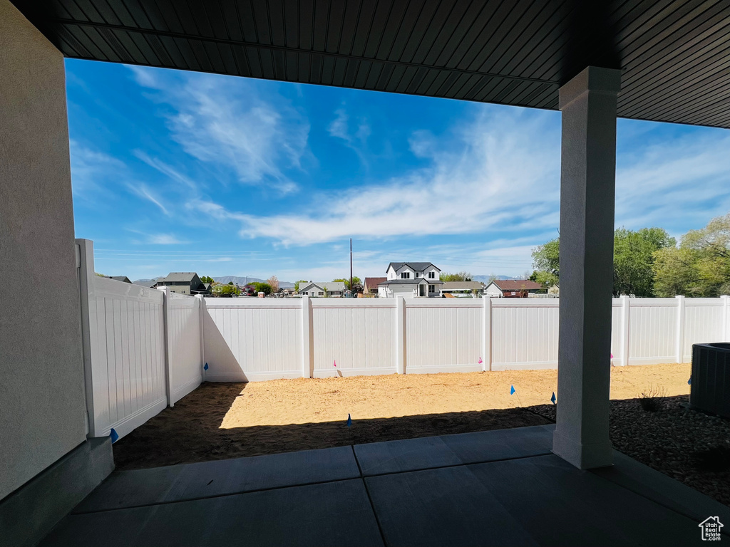 View of patio / terrace with a fenced backyard, a residential view, and cooling unit