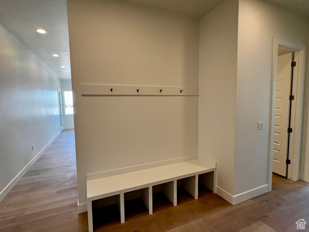 Mudroom with recessed lighting, wood finished floors, and baseboards