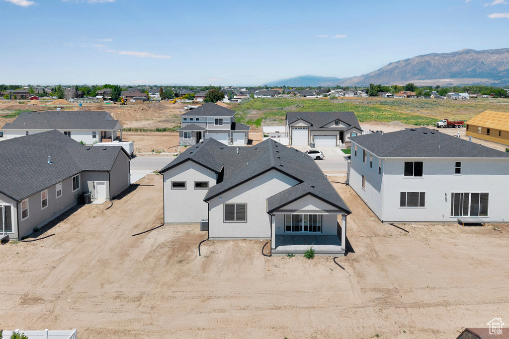 Aerial perspective of suburban area featuring a mountain backdrop