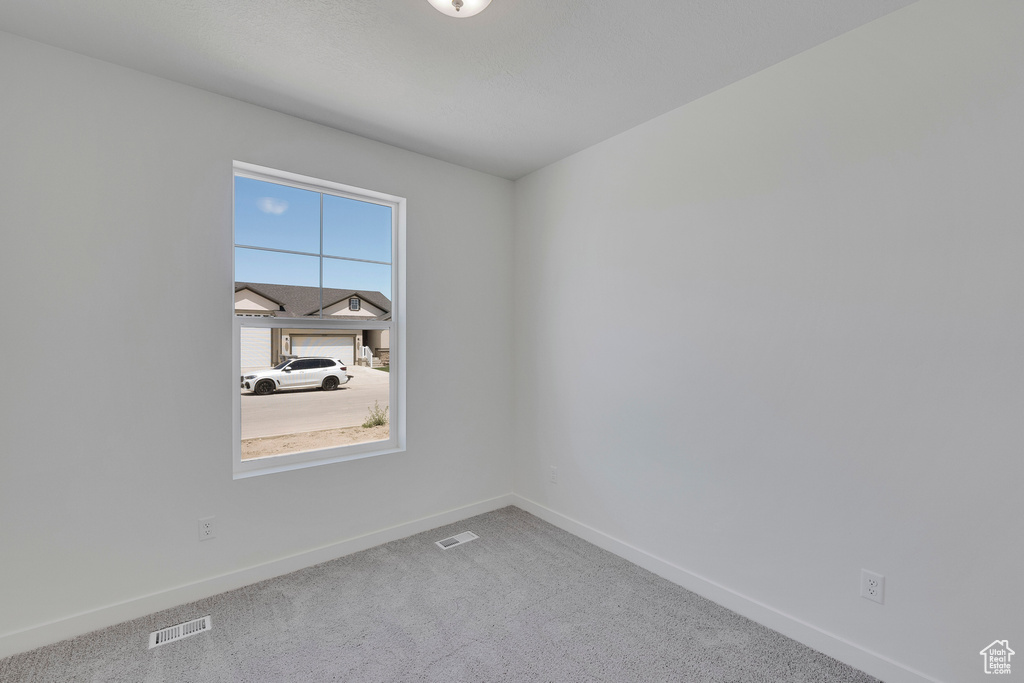 Unfurnished room featuring baseboards and carpet floors