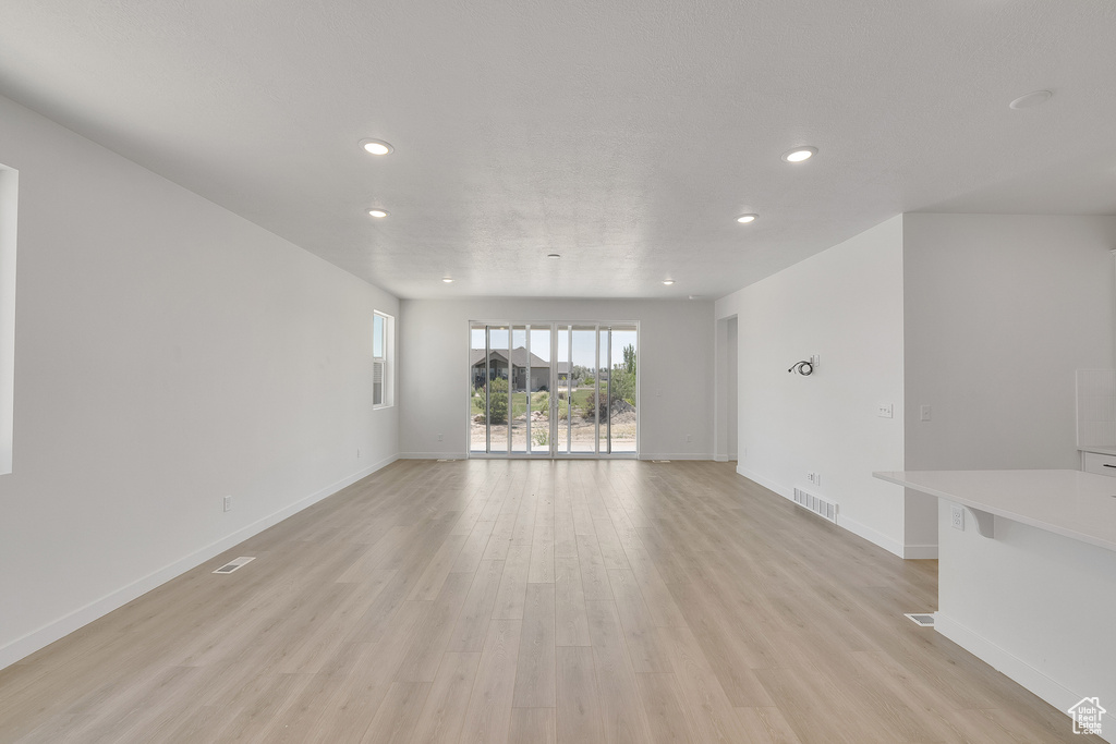 Empty room with recessed lighting and light wood finished floors