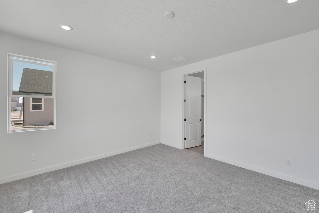 Empty room with recessed lighting and carpet flooring