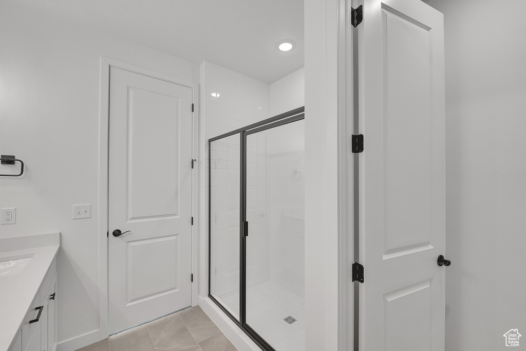 Full bathroom featuring a stall shower, vanity, and recessed lighting