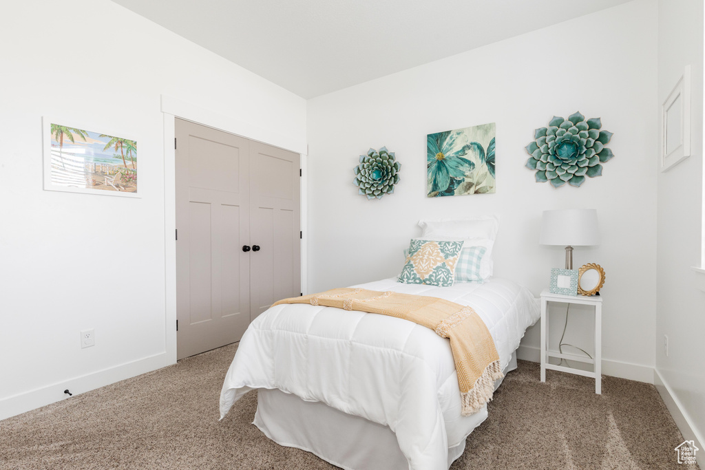 Bedroom featuring a closet, baseboards, and carpet floors