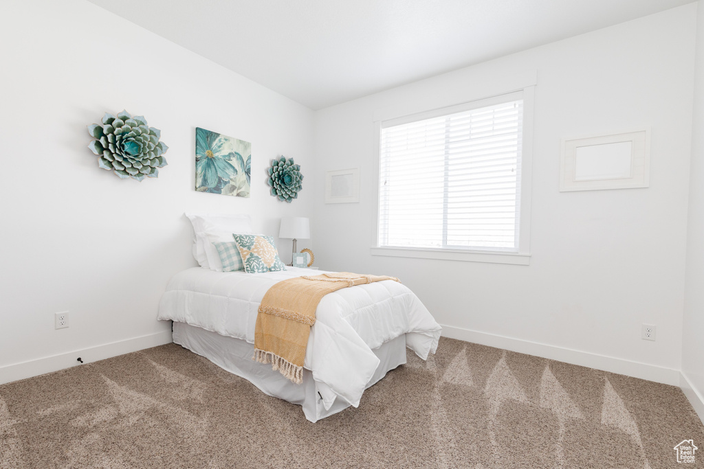Bedroom featuring baseboards and carpet floors