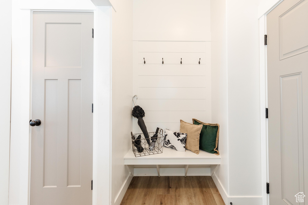 Mudroom featuring wood finished floors and baseboards