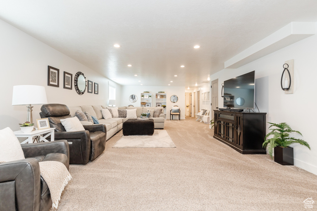 Living area with recessed lighting, baseboards, and carpet floors