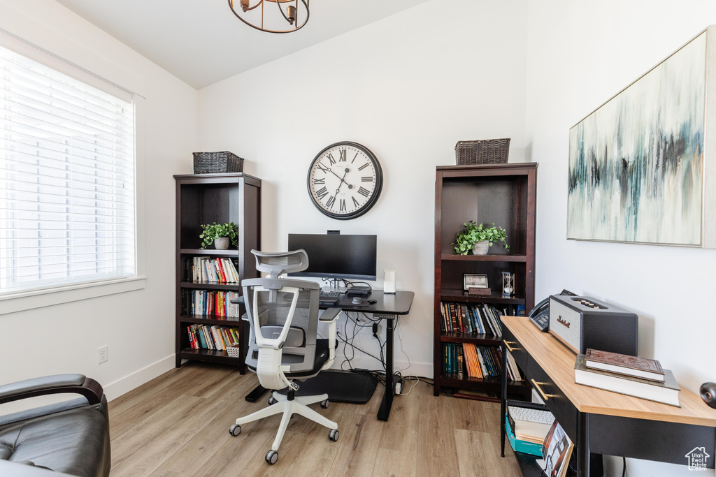 Home office with baseboards and wood finished floors