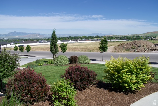Exterior space with a mountain view and a yard