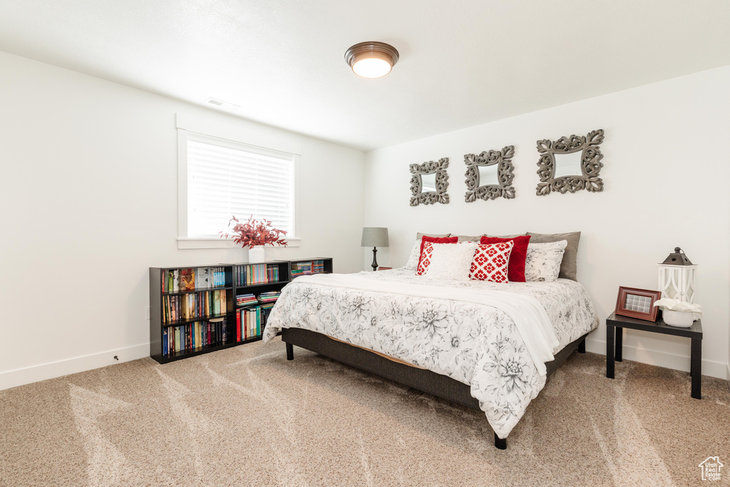 Bedroom with visible vents, carpet flooring, and baseboards