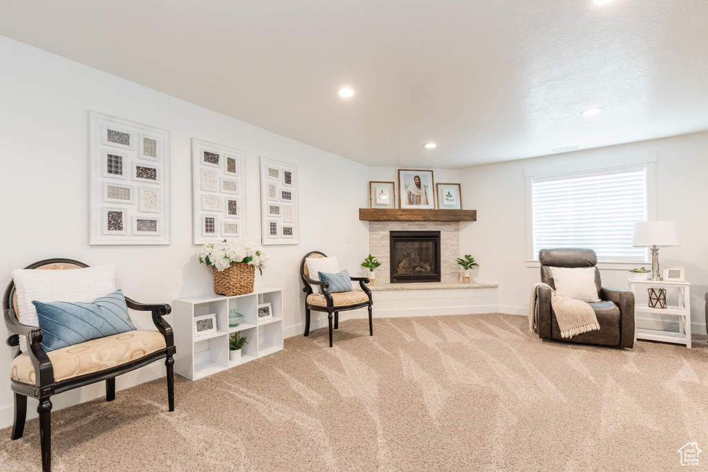Sitting room with baseboards, recessed lighting, carpet floors, and a glass covered fireplace