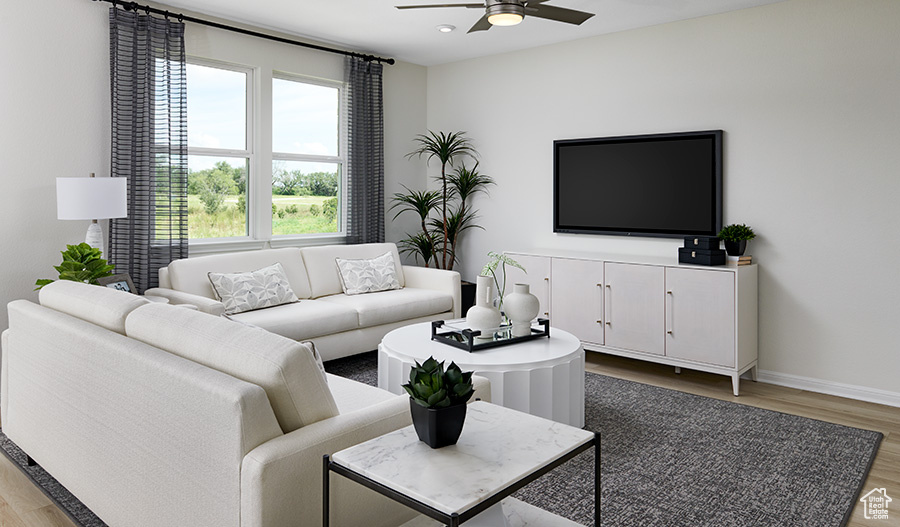 Living area with light wood finished floors, a ceiling fan, recessed lighting, and baseboards