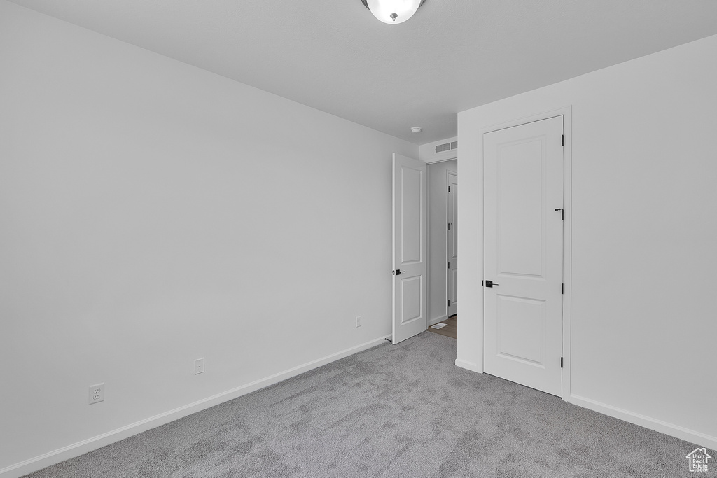 Carpeted spare room with baseboards