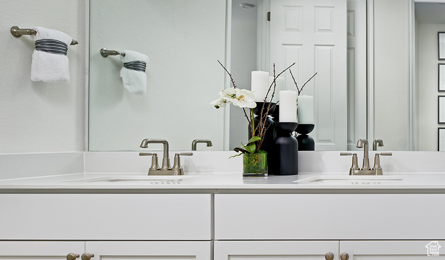 Bathroom featuring double vanity and a sink